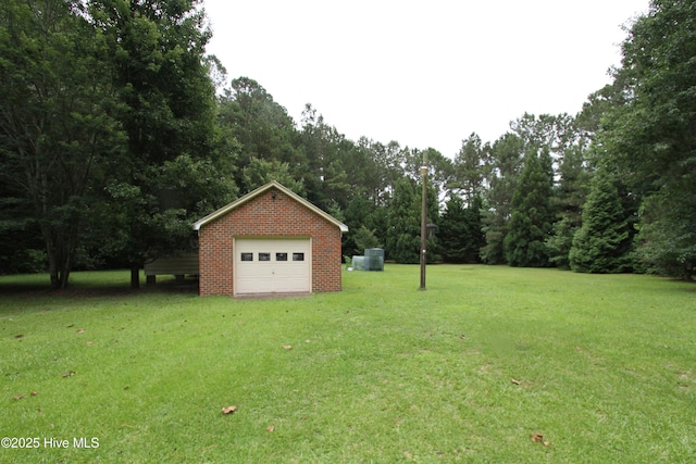 1317 Worthington Ln, Greenville, NC 27858 - view of green lawn featuring a detached garage, an outdoor structure, and driveway