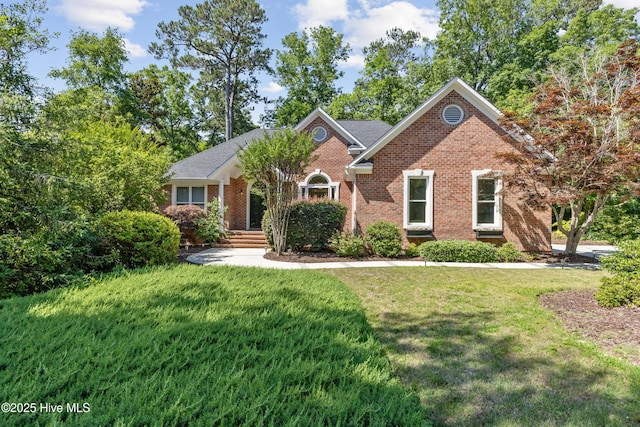8807 Sawmill Creek Ln, Wilmington, NC 28411 - view of front of home with brick siding and a front yard