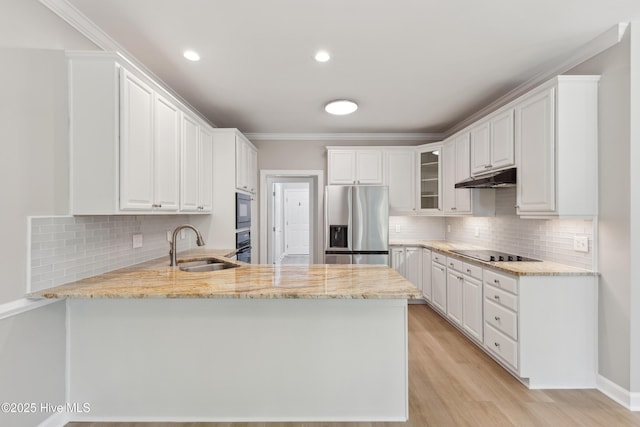 8807 Sawmill Creek Ln, Wilmington, NC 28411 - kitchen featuring black appliances, under cabinet range hood, a peninsula, a sink, and light stone countertops