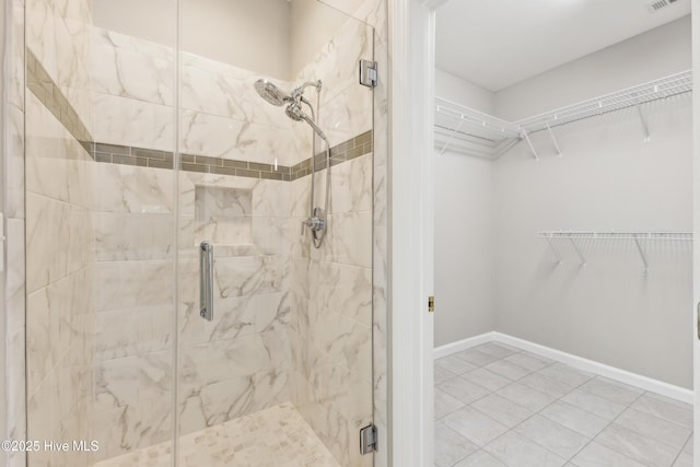 8807 Sawmill Creek Ln, Wilmington, NC 28411 - full bath with a stall shower, a walk in closet, and baseboards