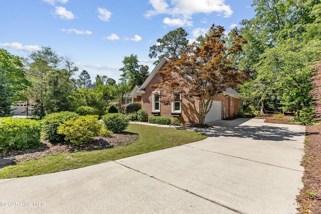 8807 Sawmill Creek Ln, Wilmington, NC 28411 - view of front of home featuring concrete driveway, brick siding, and a garage