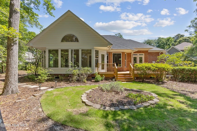 8807 Sawmill Creek Ln, Wilmington, NC 28411 - back of property with a sunroom, a wooden deck, a lawn, a shingled roof, and crawl space