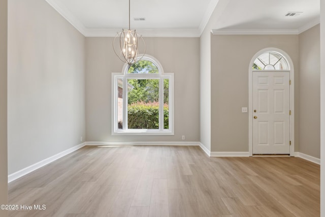 8807 Sawmill Creek Ln, Wilmington, NC 28411 - foyer featuring a chandelier, light wood-type flooring, crown molding, and baseboards