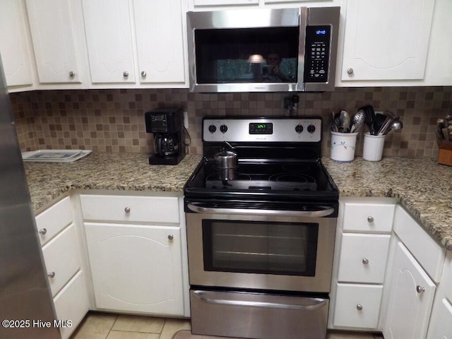 222 Rivershore Dr, New Bern, NC 28560 - kitchen featuring stainless steel appliances, white cabinetry, backsplash, and light tile patterned floors