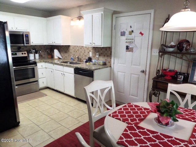 222 Rivershore Dr, New Bern, NC 28560 - kitchen featuring stainless steel appliances, a sink, white cabinets, and tasteful backsplash
