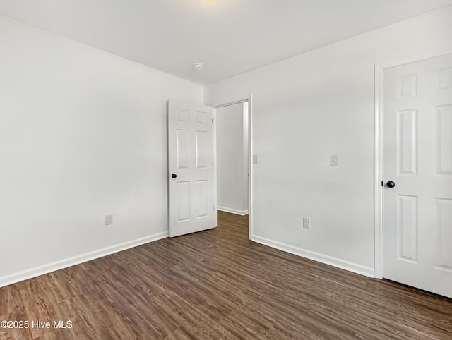 130 Summerfield St, Elizabeth City, NC 27909 - unfurnished bedroom featuring dark wood-style flooring and baseboards