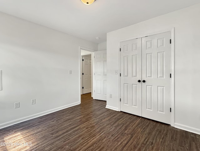 130 Summerfield St, Elizabeth City, NC 27909 - unfurnished bedroom with dark wood-style flooring, baseboards, and a closet