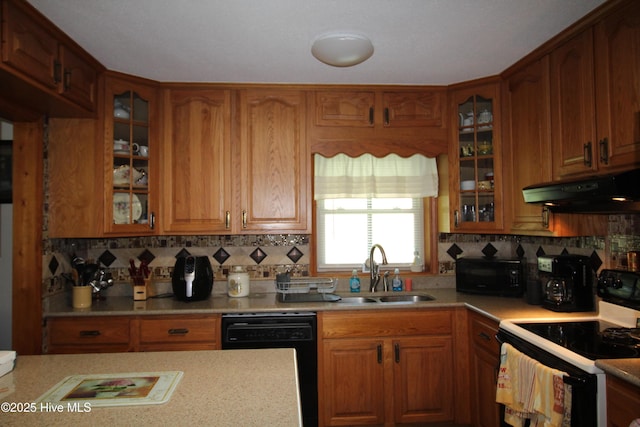 206 Stratford Rd, Havelock, NC 28532 - kitchen featuring under cabinet range hood, black appliances, a sink, light countertops, and brown cabinets