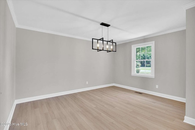 3417 Chalmers Dr, Wilmington, NC 28409 - unfurnished room with light wood-type flooring, baseboards, a chandelier, and crown molding