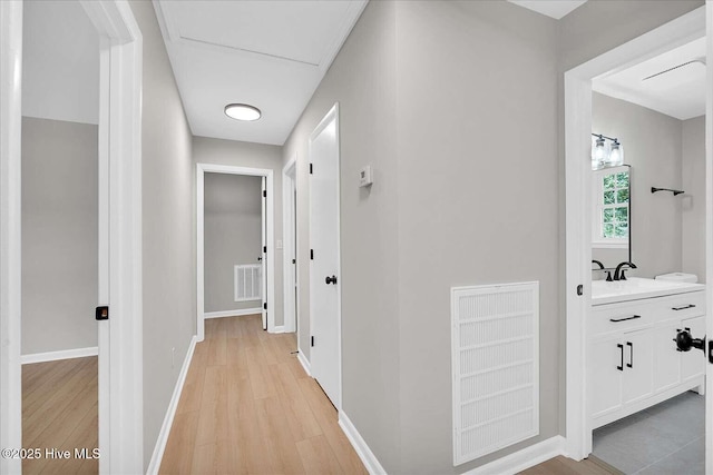 3417 Chalmers Dr, Wilmington, NC 28409 - hallway with light wood finished floors and baseboards