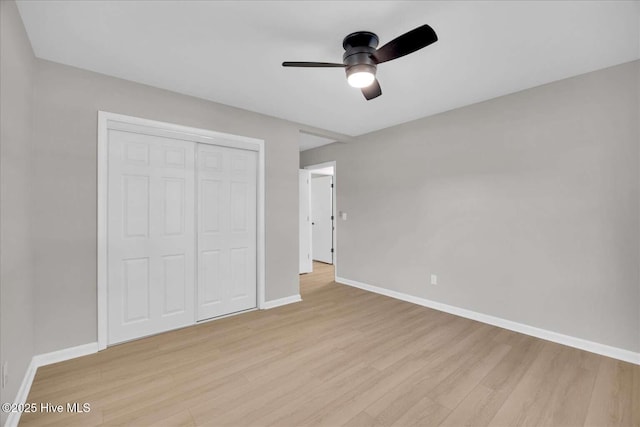 3417 Chalmers Dr, Wilmington, NC 28409 - unfurnished bedroom featuring light wood-style floors, baseboards, a closet, and a ceiling fan