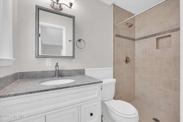 3417 Chalmers Dr, Wilmington, NC 28409 - bathroom featuring vanity, toilet, wainscoting, and tiled shower