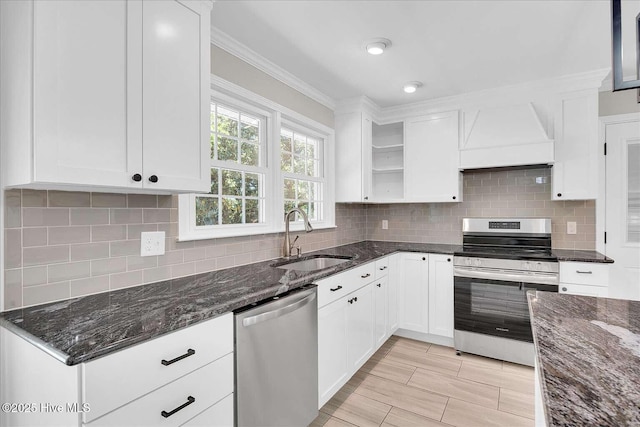 3417 Chalmers Dr, Wilmington, NC 28409 - kitchen with stainless steel appliances, a sink, premium range hood, white cabinetry, and dark stone countertops