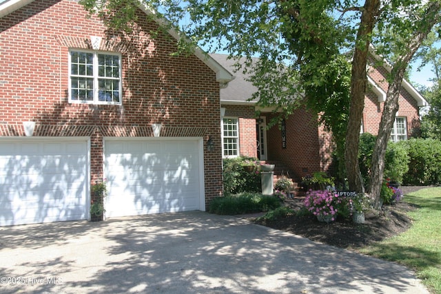 141 N River Rd, Plymouth, NC 27962 - view of front facade featuring brick siding, driveway, and an attached garage