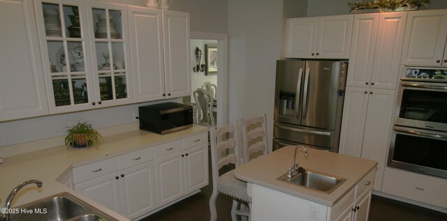 141 N River Rd, Plymouth, NC 27962 - kitchen with stainless steel appliances, a sink, white cabinets, glass insert cabinets, and light countertops