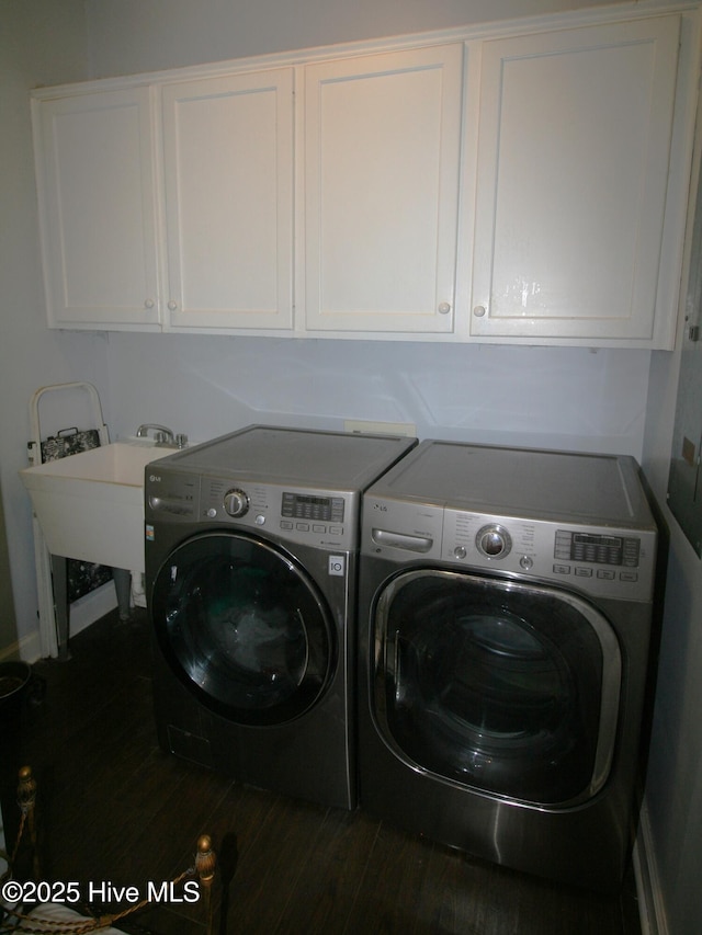 141 N River Rd, Plymouth, NC 27962 - laundry room with washer and dryer, cabinet space, dark wood finished floors, and baseboards