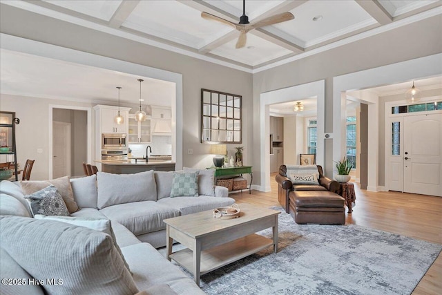 42 Spearhead Dr, Whispering Pines, NC 28327 - living room featuring ceiling fan, crown molding, coffered ceiling, light wood-type flooring, and beam ceiling