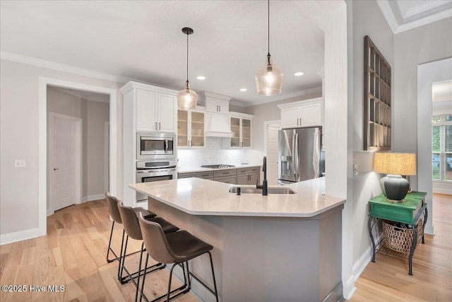 42 Spearhead Dr, Whispering Pines, NC 28327 - kitchen with stainless steel appliances, a sink, a peninsula, decorative backsplash, and a breakfast bar area