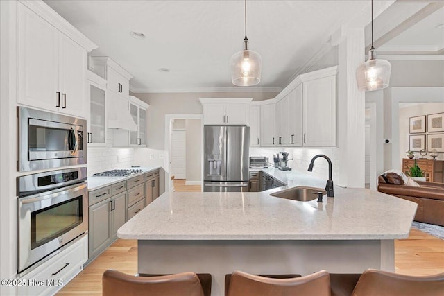 42 Spearhead Dr, Whispering Pines, NC 28327 - kitchen featuring stainless steel appliances, a sink, ornamental molding, a breakfast bar, and tasteful backsplash