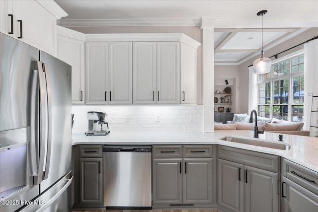 42 Spearhead Dr, Whispering Pines, NC 28327 - kitchen featuring appliances with stainless steel finishes, a sink, gray cabinets, crown molding, and backsplash