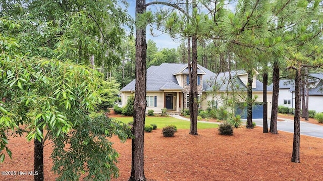 42 Spearhead Dr, Whispering Pines, NC 28327 - view of front of house with driveway, a front lawn, and an attached garage