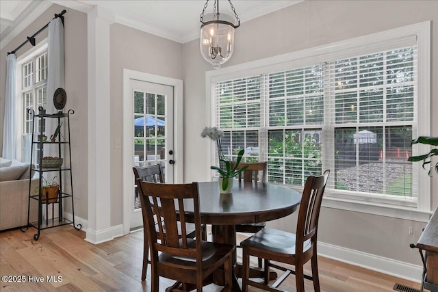 42 Spearhead Dr, Whispering Pines, NC 28327 - dining room featuring crown molding, light wood finished floors, healthy amount of natural light, and baseboards