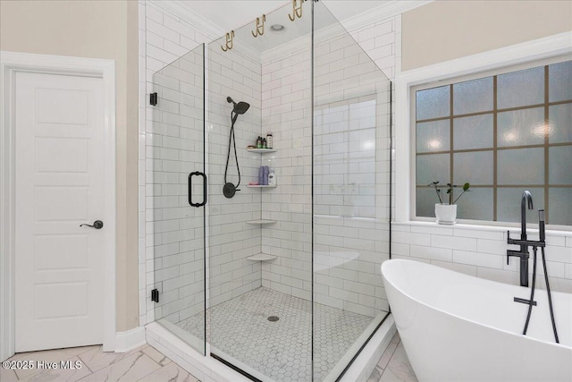 42 Spearhead Dr, Whispering Pines, NC 28327 - bathroom with marble look tiles, a freestanding tub, a shower stall, and ornamental molding