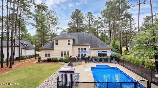 42 Spearhead Dr, Whispering Pines, NC 28327 - rear view of property featuring a patio area, a shingled roof, and view of scattered trees