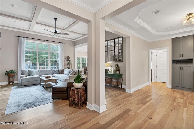 42 Spearhead Dr, Whispering Pines, NC 28327 - living room featuring light wood-style floors, a ceiling fan, baseboards, crown molding, and beamed ceiling