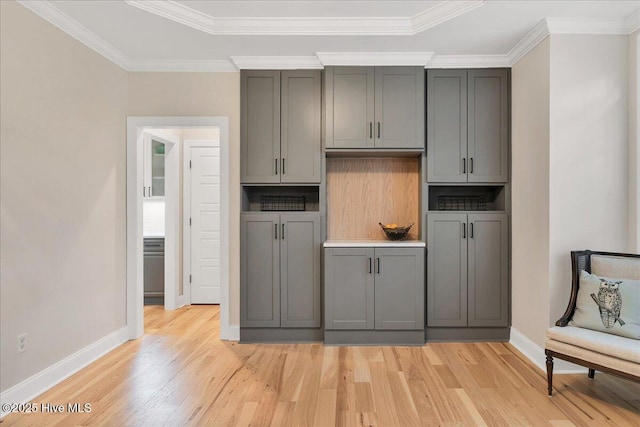42 Spearhead Dr, Whispering Pines, NC 28327 - kitchen with light wood-style floors, gray cabinets, baseboards, and ornamental molding