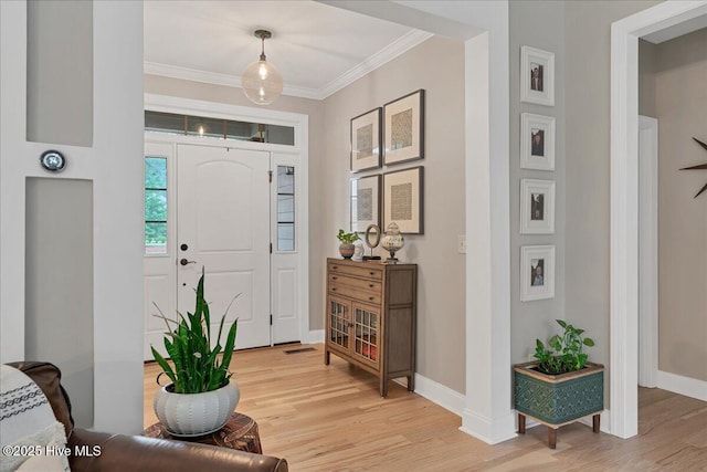 42 Spearhead Dr, Whispering Pines, NC 28327 - foyer with light wood finished floors, ornamental molding, and baseboards
