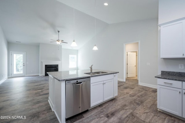 2958 Old Berwick St SW, Shallotte, NC 28470 - kitchen with dishwasher, a sink, ceiling fan, a glass covered fireplace, and white cabinets