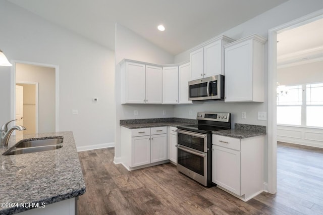 2958 Old Berwick St SW, Shallotte, NC 28470 - kitchen featuring stainless steel appliances, white cabinetry, dark wood-style flooring, lofted ceiling, and recessed lighting