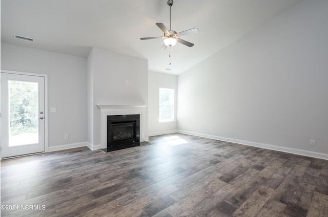 2958 Old Berwick St SW, Shallotte, NC 28470 - unfurnished living room with dark wood-style flooring, ceiling fan, a fireplace with flush hearth, vaulted ceiling, and baseboards