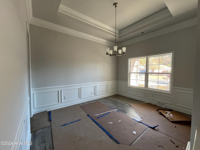2958 Old Berwick St SW, Shallotte, NC 28470 - spare room featuring a tray ceiling, ornamental molding, a chandelier, wainscoting, and a decorative wall