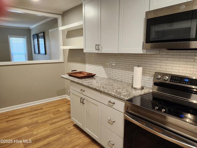 1108 Plymouth Dr, New Bern, NC 28562 - kitchen featuring appliances with stainless steel finishes, open shelves, crown molding, white cabinets, and light wood-style flooring