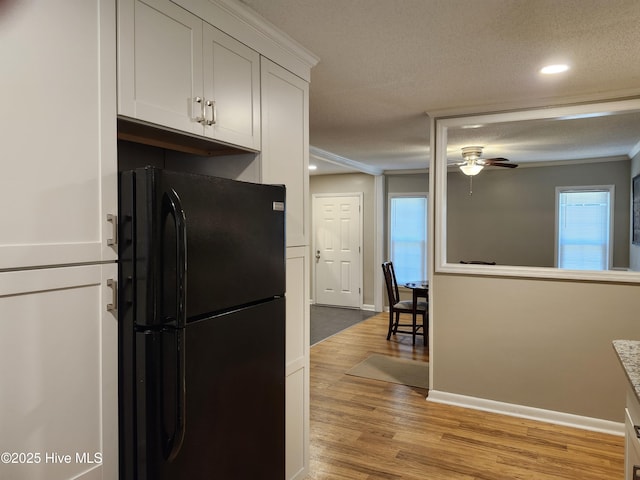 1108 Plymouth Dr, New Bern, NC 28562 - kitchen with freestanding refrigerator, a ceiling fan, light wood-style floors, healthy amount of natural light, and recessed lighting