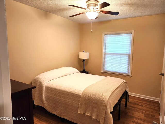 1108 Plymouth Dr, New Bern, NC 28562 - bedroom featuring wood finished floors, a textured ceiling, baseboards, and a ceiling fan