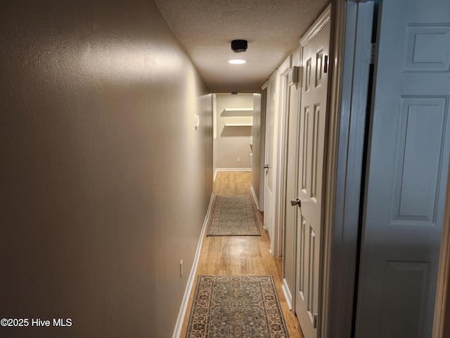 1108 Plymouth Dr, New Bern, NC 28562 - hallway featuring baseboards, light wood-type flooring, and a textured ceiling