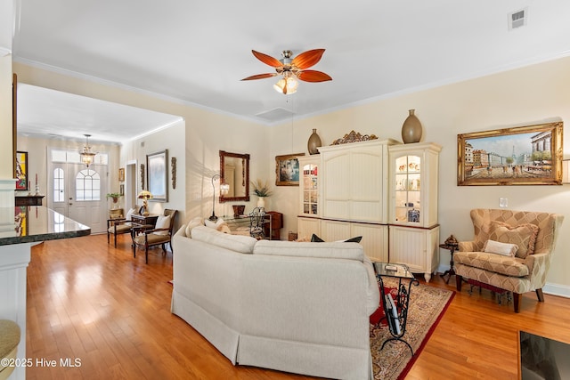 770 Creekway Cir SE, Bolivia, NC 28422 - living room featuring light wood-type flooring, ceiling fan, and crown molding