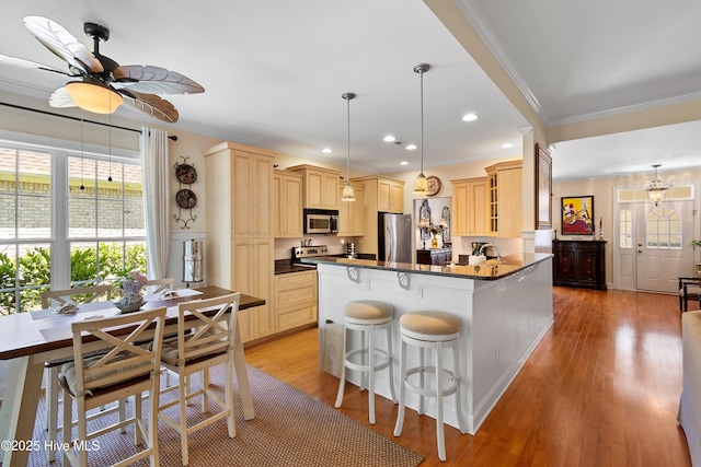 770 Creekway Cir SE, Bolivia, NC 28422 - kitchen featuring stainless steel appliances, dark countertops, light brown cabinets, ornamental molding, and a ceiling fan
