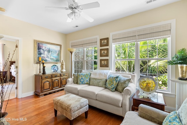 770 Creekway Cir SE, Bolivia, NC 28422 - living room featuring light wood-style flooring, ceiling fan, and baseboards