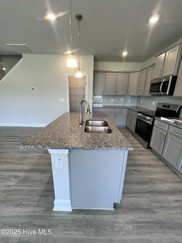 5022 Holly Hill Ct, Battleboro, NC 27809 - kitchen with stainless steel appliances, a sink, gray cabinets, and wood finished floors
