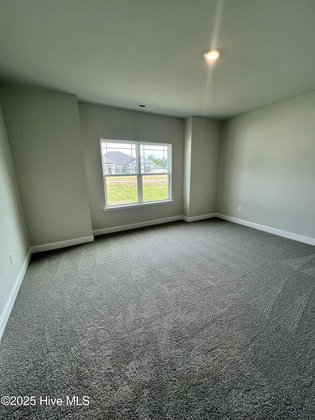 5022 Holly Hill Ct, Battleboro, NC 27809 - empty room with dark carpet and baseboards