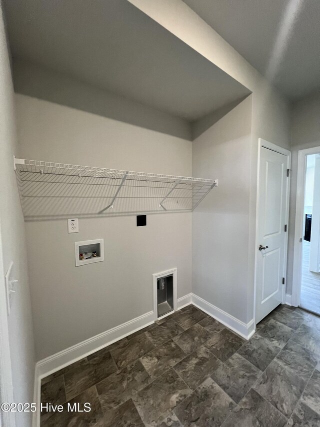 5022 Holly Hill Ct, Battleboro, NC 27809 - laundry area featuring baseboards, washer hookup, dark stone finish flooring, and electric dryer hookup