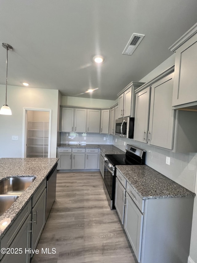 5022 Holly Hill Ct, Battleboro, NC 27809 - kitchen featuring stainless steel appliances, gray cabinets, stone countertops, hanging light fixtures, and recessed lighting