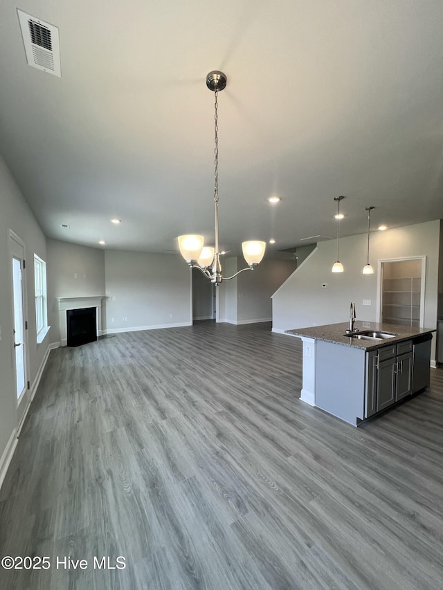 5022 Holly Hill Ct, Battleboro, NC 27809 - kitchen with open floor plan, a sink, wood finished floors, baseboards, and recessed lighting
