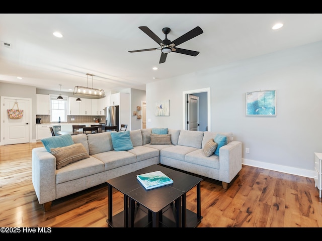 119 NE 27th St, Oak Island, NC 28465 - living room with a ceiling fan, recessed lighting, light wood-type flooring, and baseboards