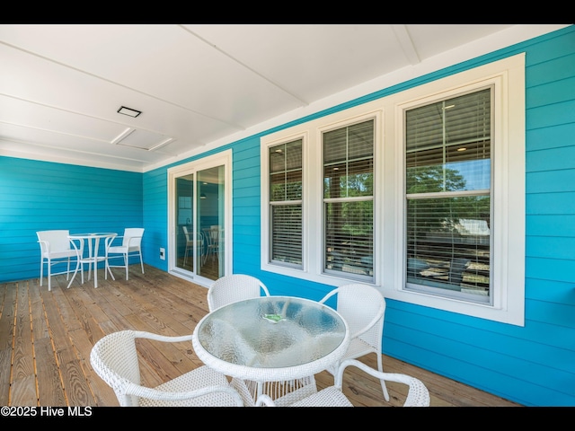 119 NE 27th St, Oak Island, NC 28465 - wooden deck featuring outdoor dining space