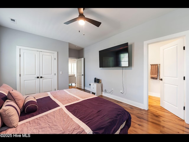 119 NE 27th St, Oak Island, NC 28465 - bedroom with light wood-style flooring, baseboards, a closet, and a ceiling fan